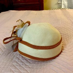 Feathered, cloche hat. Stylish cream hat.